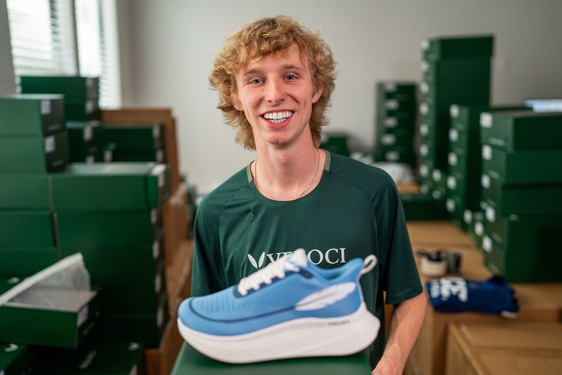Tyler Strothman, Rice University Sport Management student holding a shoe