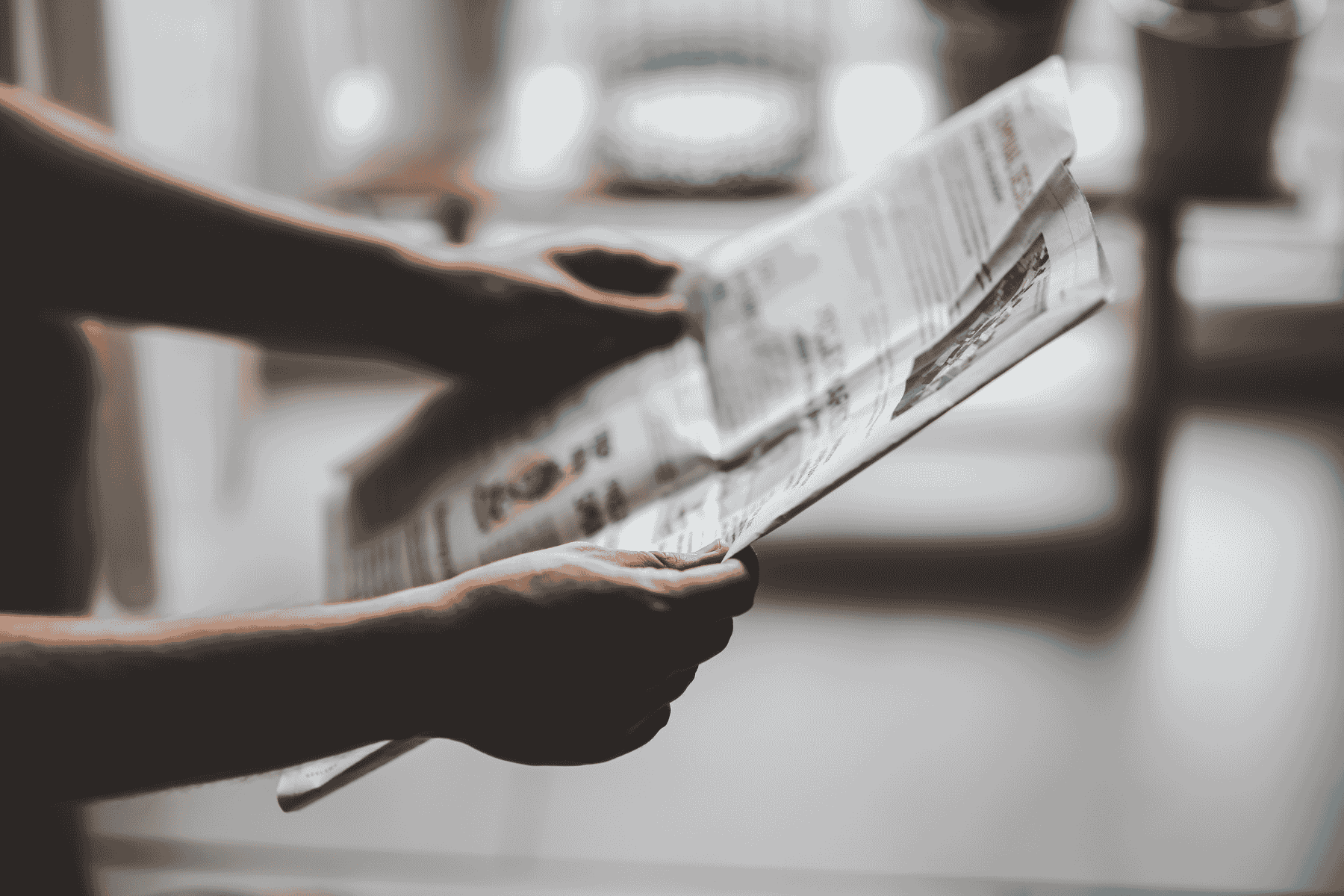 hands holding a newspaper, Rice University Political Science