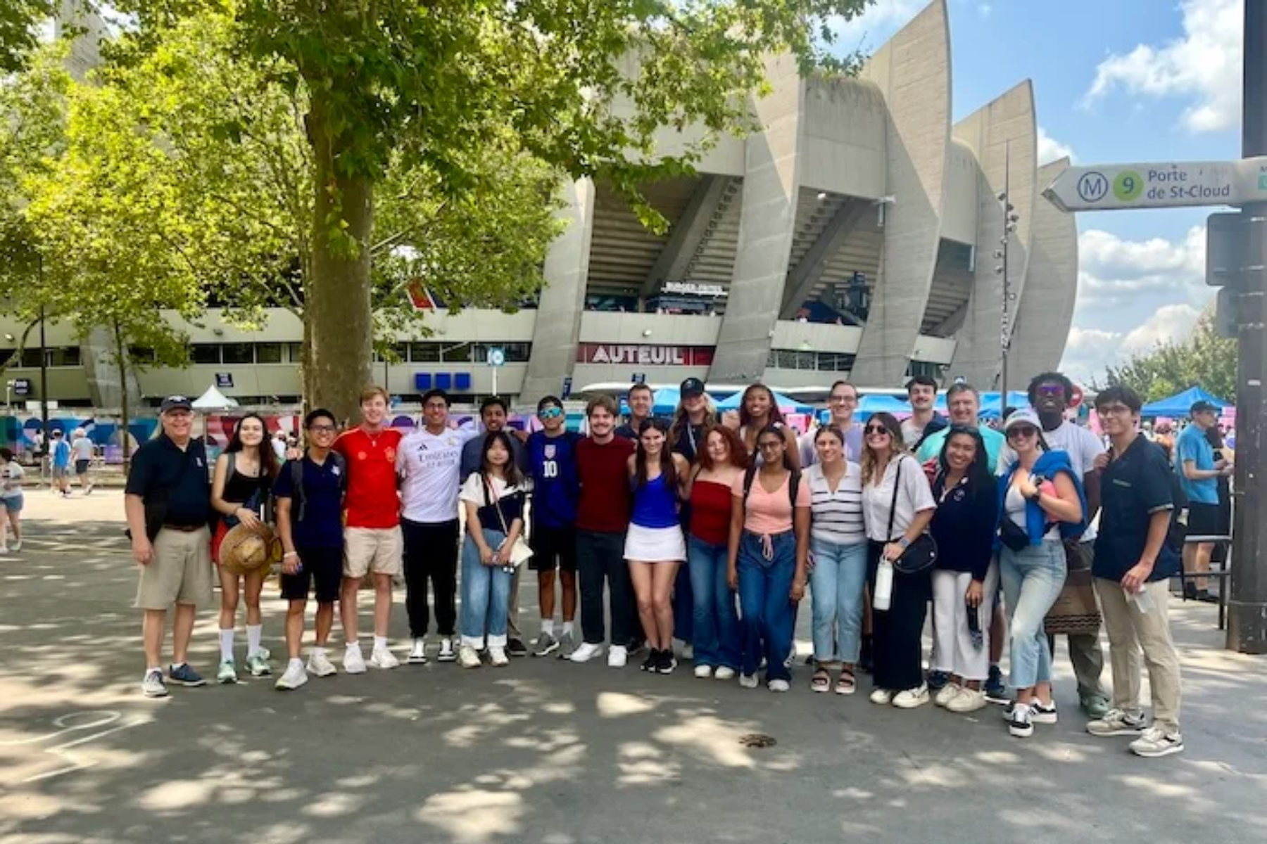 Group of people standing outside in front of stadium